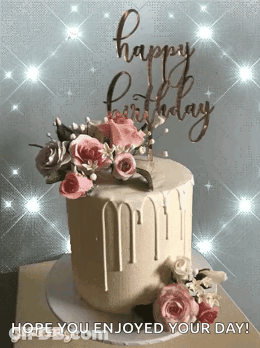 A Birthday Cake With Flowers And A Happy Birthday Sign GIF