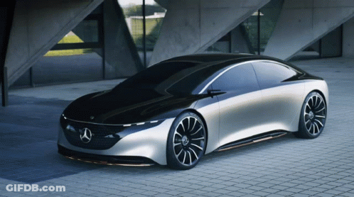 A Black And Silver Mercedes Is Parked On A Brick Sidewalk GIF