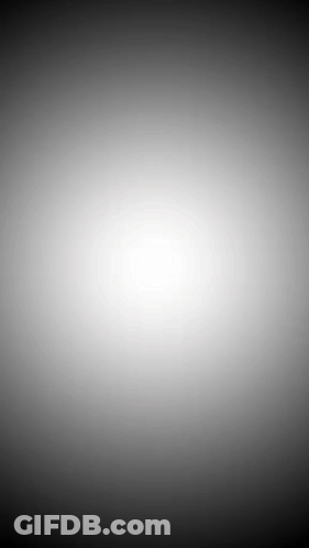 A Black And White Background With A Glowing White Circle In The Middle . GIF