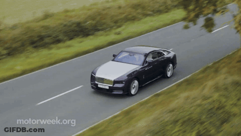 A Black And White Car Is Driving Down A Road With Motorweek.org In The Corner GIF