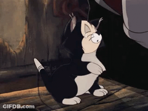 A Black And White Cartoon Cat Is Sitting On A Wooden Floor Next To A Person . GIF
