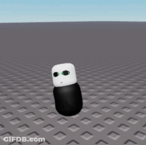 A Black And White Cartoon Character With Green Eyes Is Standing On A Gray Surface GIF