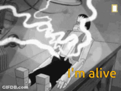 A Black And White Cartoon Of A Robot Laying On A Table With The Words I 'M Alive Above It GIF