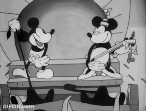 A Black And White Cartoon Of Mickey Mouse Playing A Guitar GIF