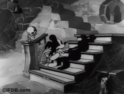A Black And White Cartoon Of Mickey Mouse Sitting On A Set Of Stairs With A Skeleton In The Background . GIF
