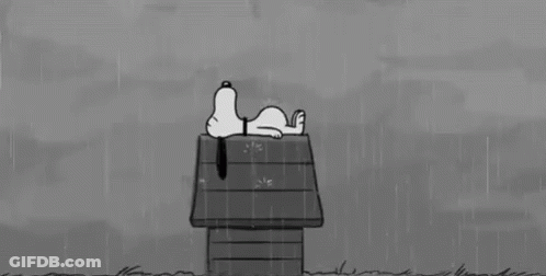 A Black And White Cartoon Of Snoopy Laying On A Doghouse In The Rain . GIF