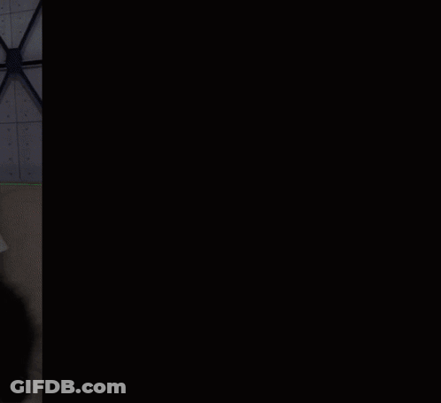 A Black And White Cat Wearing A White Shirt That Says I Heart Blue-Rock GIF