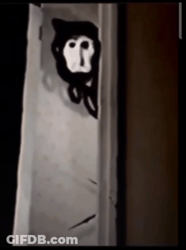 A Black And White Drawing Of A Monkey Peeking Out From Behind A Door GIF