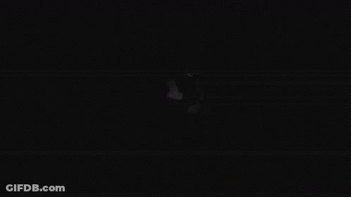 A Black And White Drawing Of A Person 'S Face With Big Eyes In The Dark . GIF
