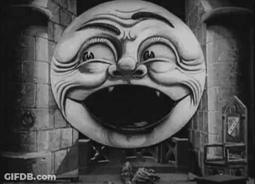 A Black And White Drawing Of A Smiling Face In Front Of A Castle Tower GIF