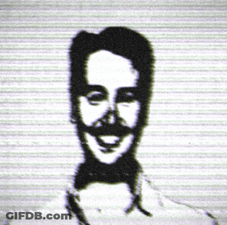 A Black And White Image Of A Man With A Mustache And Bow Tie GIF