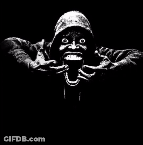 A Black And White Image Of A Man With His Mouth Open And A Hand Holding A Sign That Says 67 < 61 GIF
