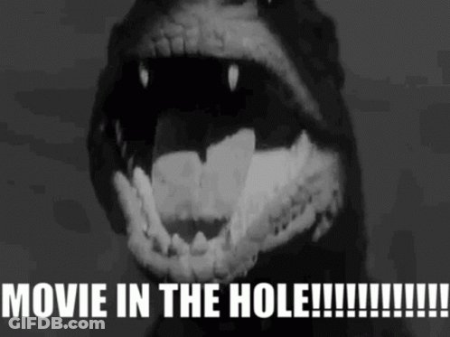 A Black And White Image Of A Monster With The Words Movie In The Hole Written Below It GIF