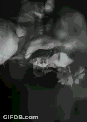 A Black And White Image Of A Person 'S Face With A Green Background GIF