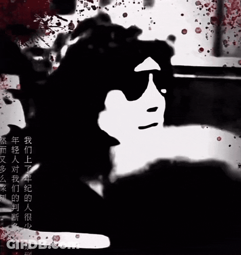A Black And White Image Of A Person 'S Face With Blood Splashing Around It GIF