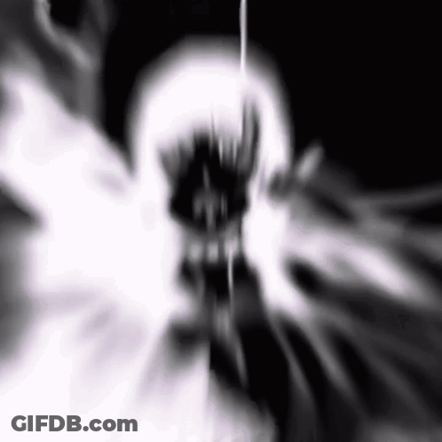A Black And White Image Of A Skull With A Glowing Mouth And Teeth . GIF