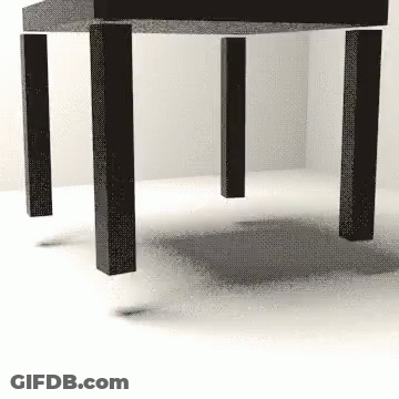 A Black And White Image Of A Table With A Shadow On The Floor GIF