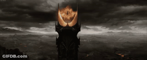 A Black And White Image Of A Tower With A Glowing Eye GIF