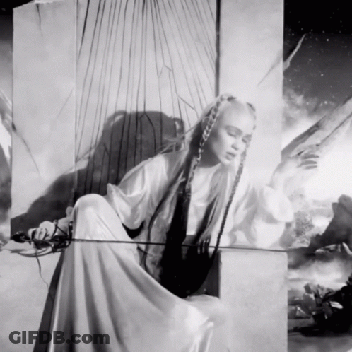 A Black And White Painting Of A Woman With Long Hair GIF
