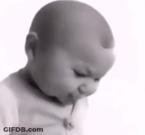 Baby Eating Lollipop In Black And White GIF