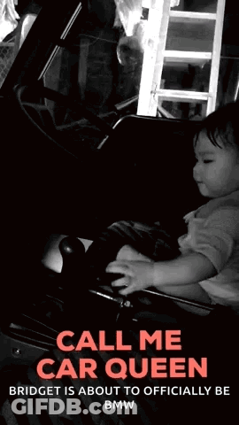 A Black And White Photo Of A Baby Holding A Steering Wheel With The Words Call Me Car Queen GIF