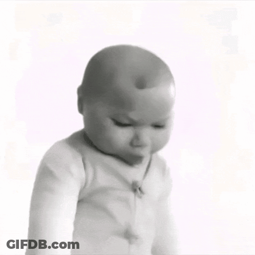 A Black And White Photo Of A Baby Looking Down GIF