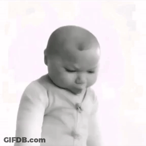 A Black And White Photo Of A Baby Wearing A White Sweater . GIF
