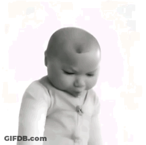 A Black And White Photo Of A Baby With A Bald Head . GIF