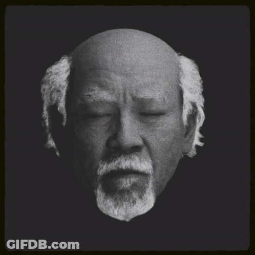 A Black And White Photo Of A Bald Man With A Beard And The Words Miyagi New Buy On The Bottom GIF