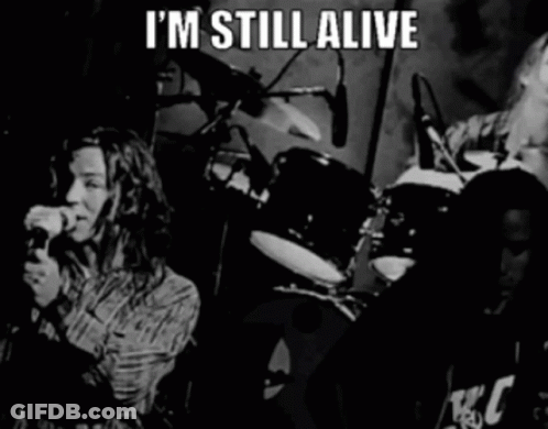 A Black And White Photo Of A Band With The Words " I 'M Still Alive " GIF