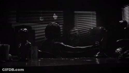 A Black And White Photo Of A Banker 'S Lamp In Front Of A Window GIF