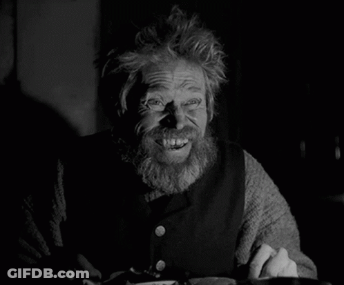 A Black And White Photo Of A Bearded Man Smiling GIF