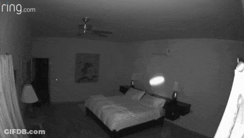 A Black And White Photo Of A Bedroom With The Website Ring.com GIF