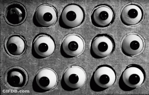 A Black And White Photo Of A Box Of Eyes GIF