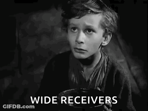 A Black And White Photo Of A Boy Holding A Bowl That Says I Want Some More GIF
