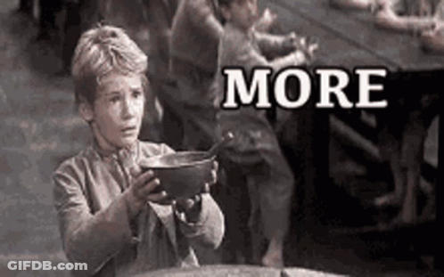 A Black And White Photo Of A Boy Holding A Bowl With The Word More Written On It . GIF