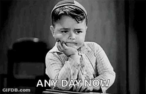 A Black And White Photo Of A Boy Sitting At A Desk With His Hand On His Chin And The Words `` Any Day Now '' . GIF