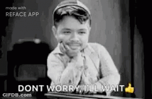 A Black And White Photo Of A Boy Sitting At A Table With His Hand On His Chin And A Thumbs Up . GIF