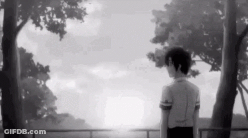 A Black And White Photo Of A Boy Standing In Front Of A Fence Looking At The Sun . GIF
