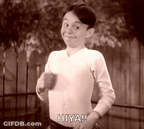 A Black And White Photo Of A Boy With The Word Hiya On His Shirt GIF