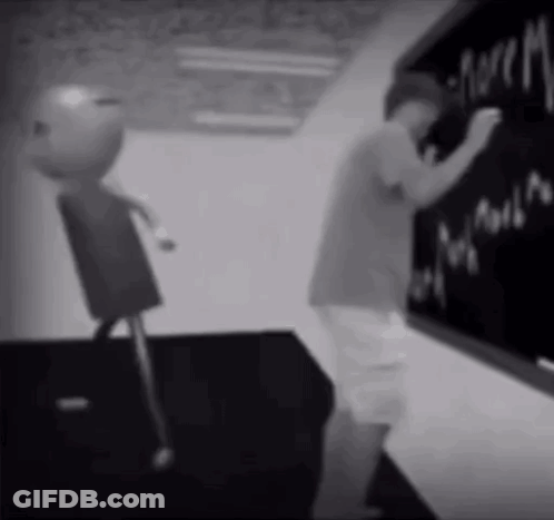 A Black And White Photo Of A Boy Writing On A Chalkboard .. GIF