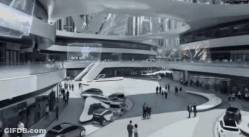 A Black And White Photo Of A Building With Cars Parked In The Middle GIF