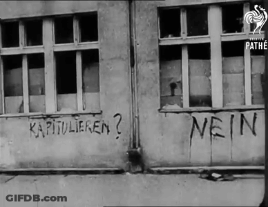 A Black And White Photo Of A Building With Nein Written On It GIF