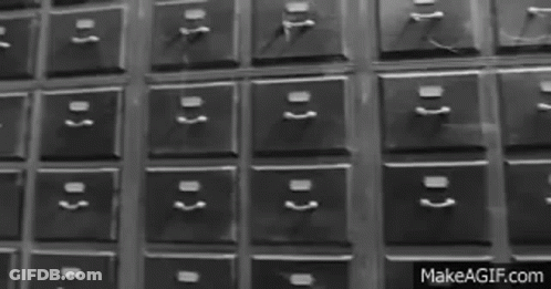 A Black And White Photo Of A Bunch Of Drawers With Numbers On Them GIF