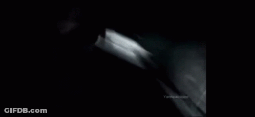 A Black And White Photo Of A Car Going Down A Hill GIF