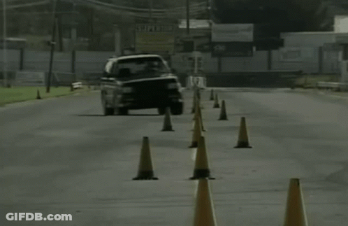 A Black And White Photo Of A Car On A Road GIF