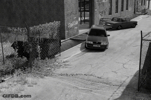 A Black And White Photo Of A Car With A License Plate That Starts With The Letter S GIF