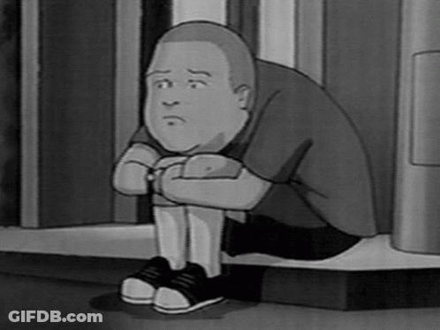 A Black And White Photo Of A Cartoon Character Sitting On The Floor . GIF