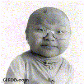 A Black And White Photo Of A Child Wearing Glasses And A Turtleneck GIF