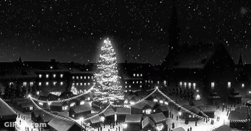 A Black And White Photo Of A Christmas Market With A Christmas Tree In The Middle Of It . GIF